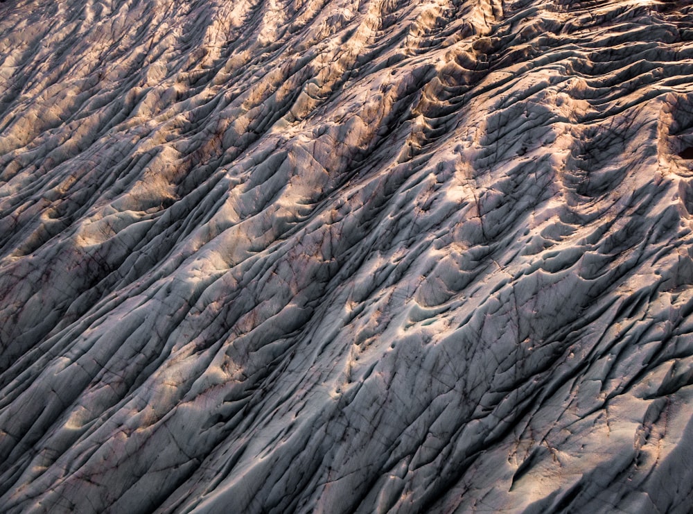 an aerial view of a rocky area with sand and grass