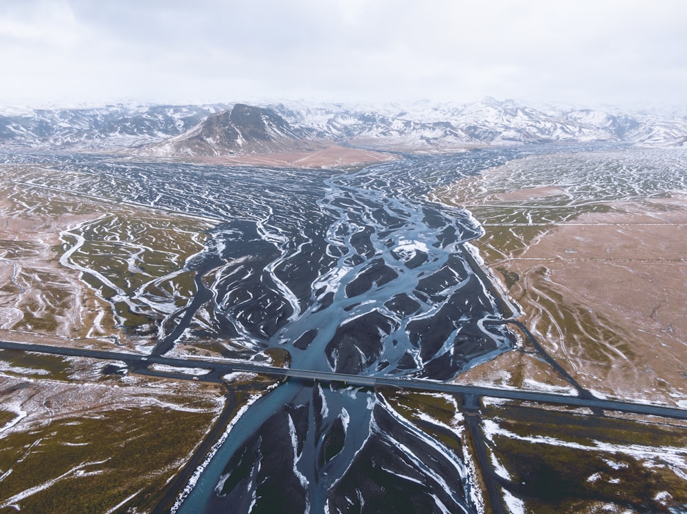 an aerial view of a river running through a valley