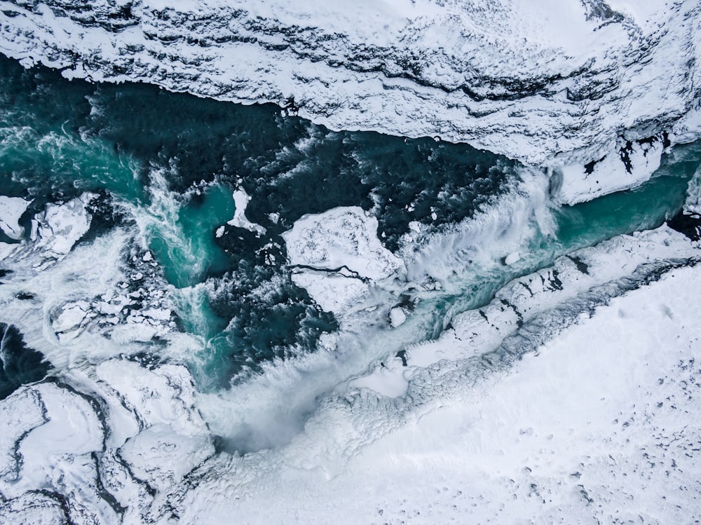 an aerial view of a body of water covered in snow