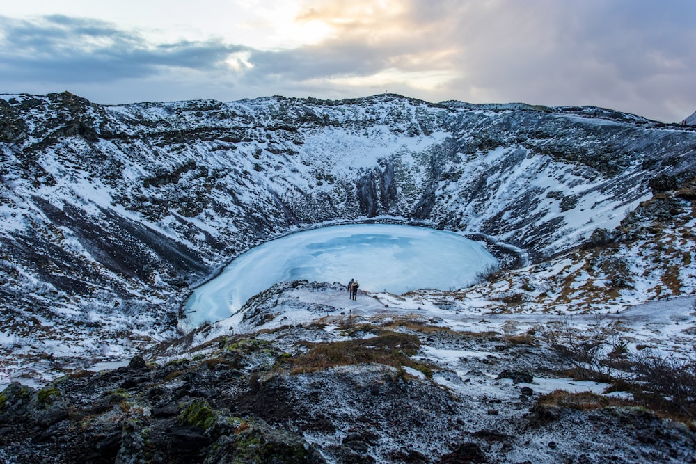 a man standing on top of a snow covered mountain