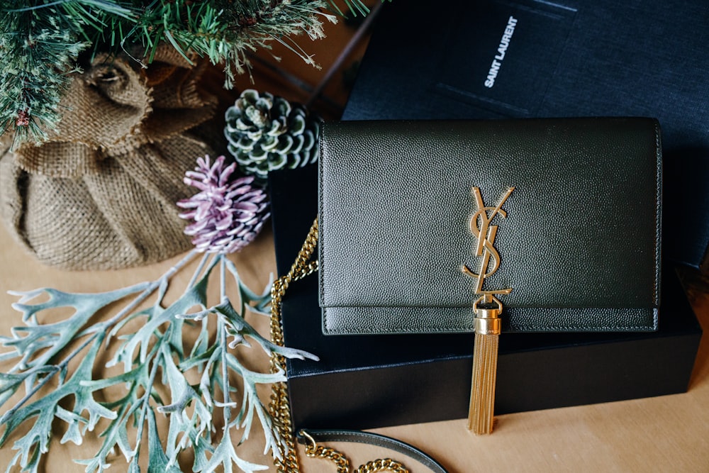 black and gold book on brown wooden table