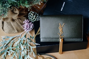 black and gold book on brown wooden table