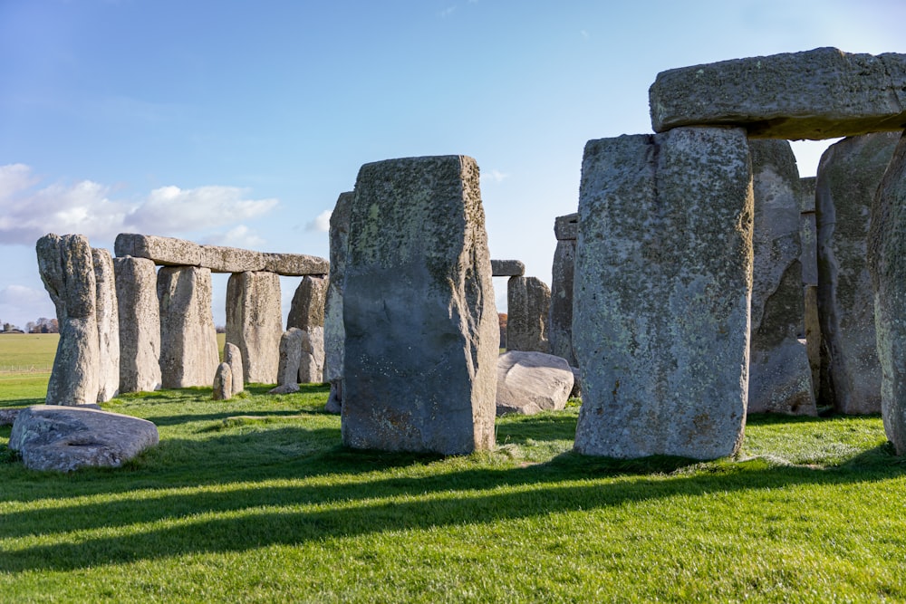 gray rock formation on green grass field during daytime