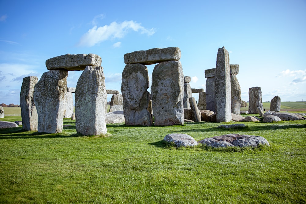 gray rock formation on green grass field during daytime