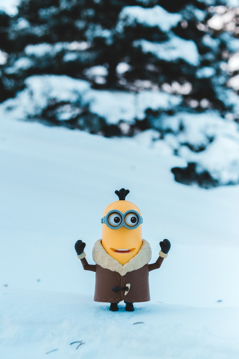 a toy figure of a minion standing in the snow