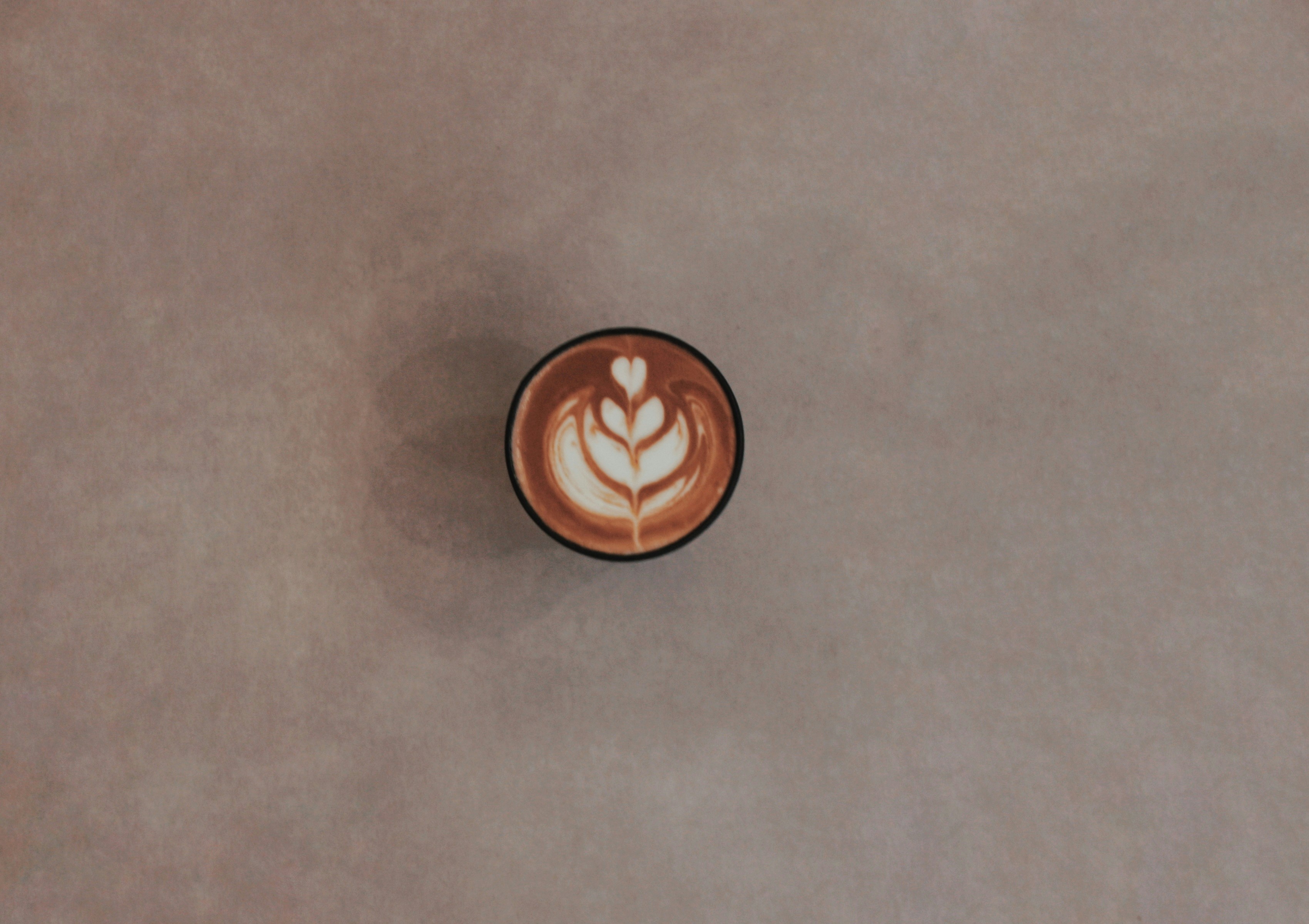 brown ceramic mug on gray table