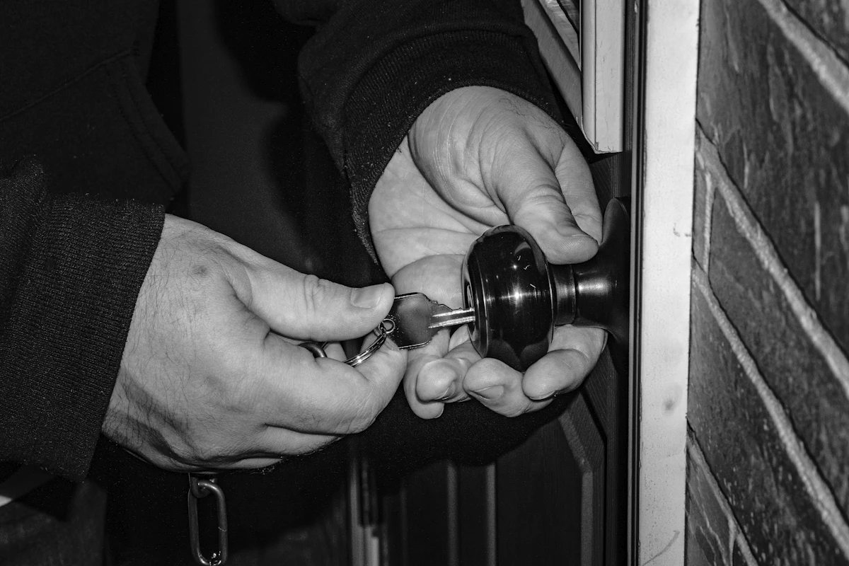 Hands working on a lock cylinder with the key in it