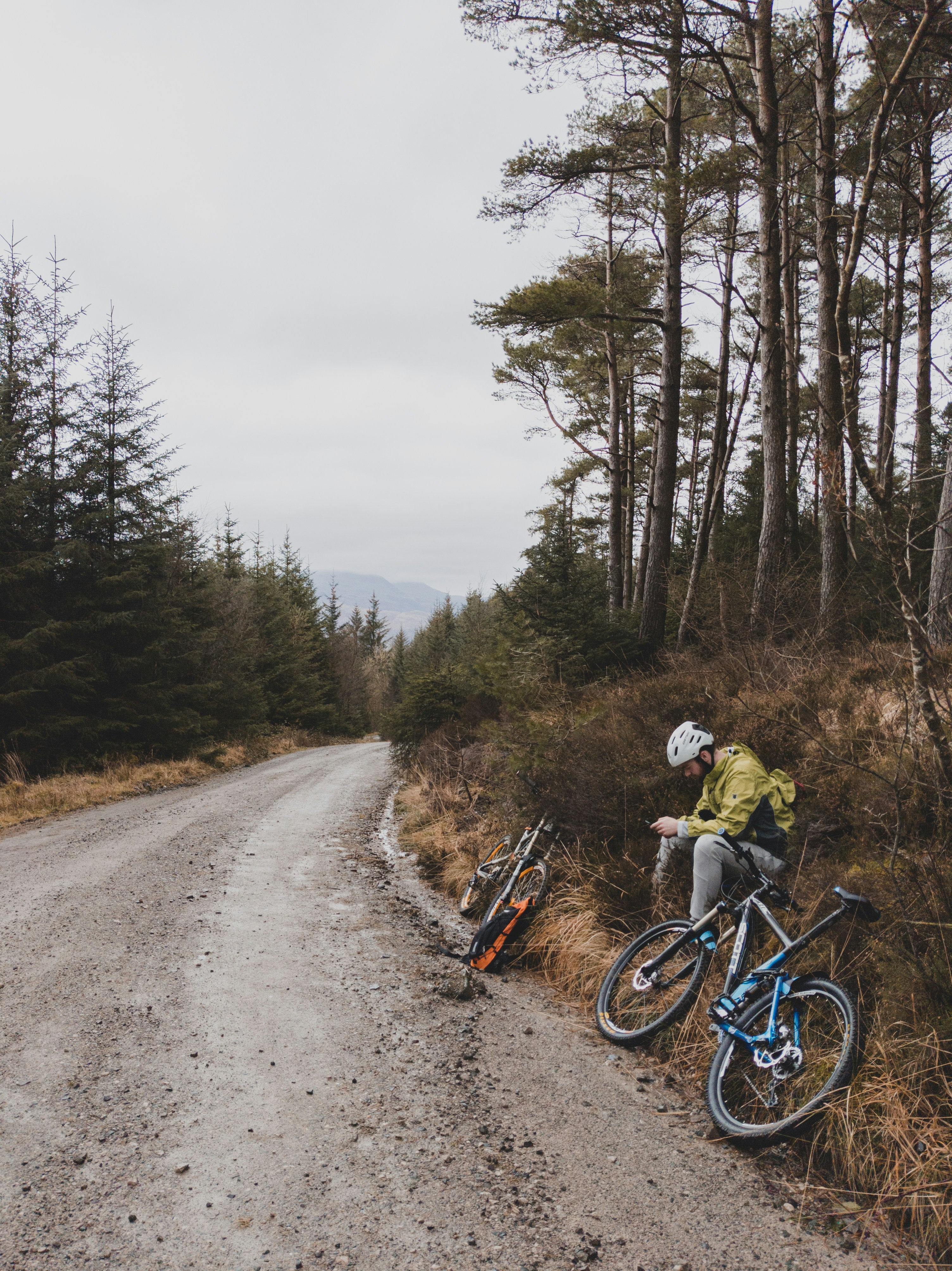 man in black jacket riding bicycle on road during daytime