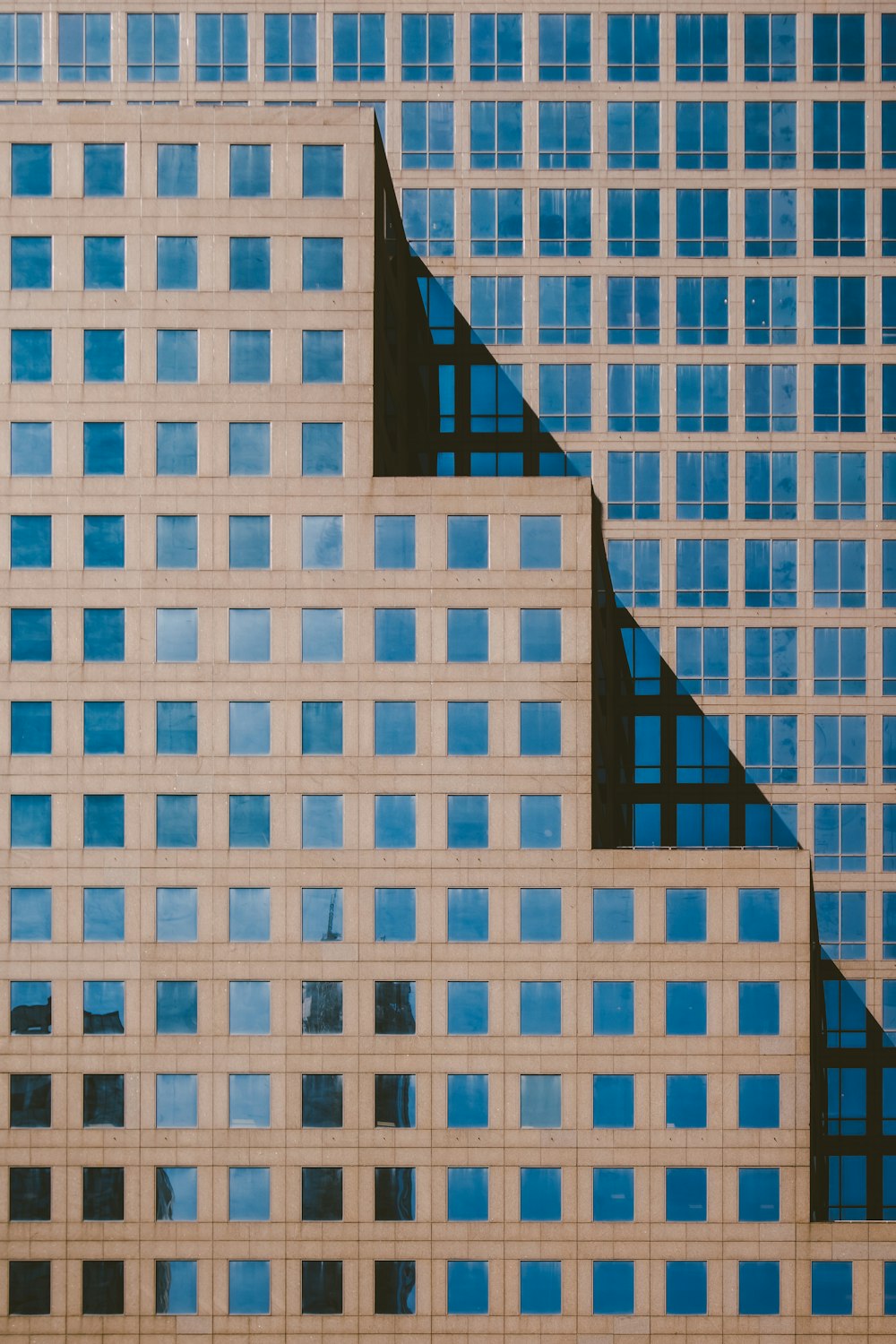 a tall building with many windows and a clock