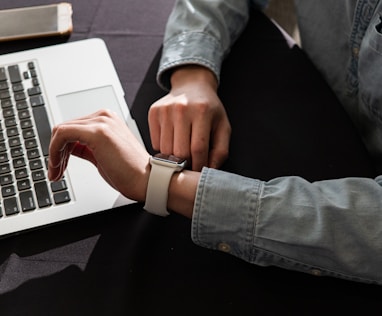 person in blue denim jacket using macbook pro