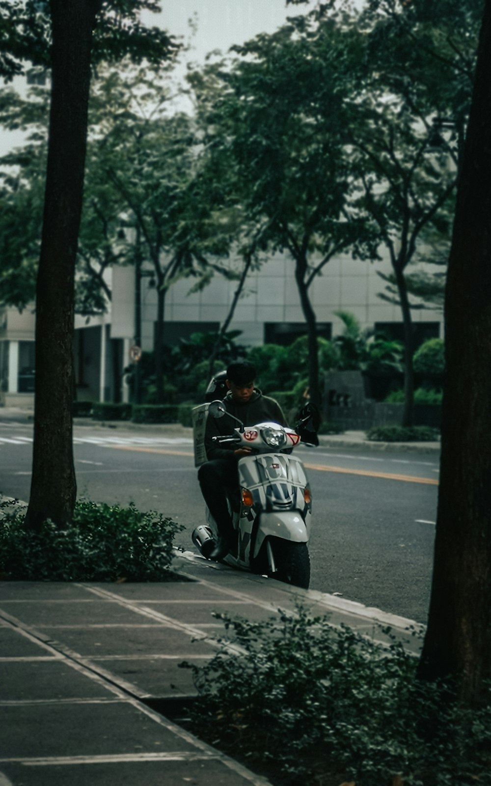 man in black jacket riding on black motorcycle on road during daytime