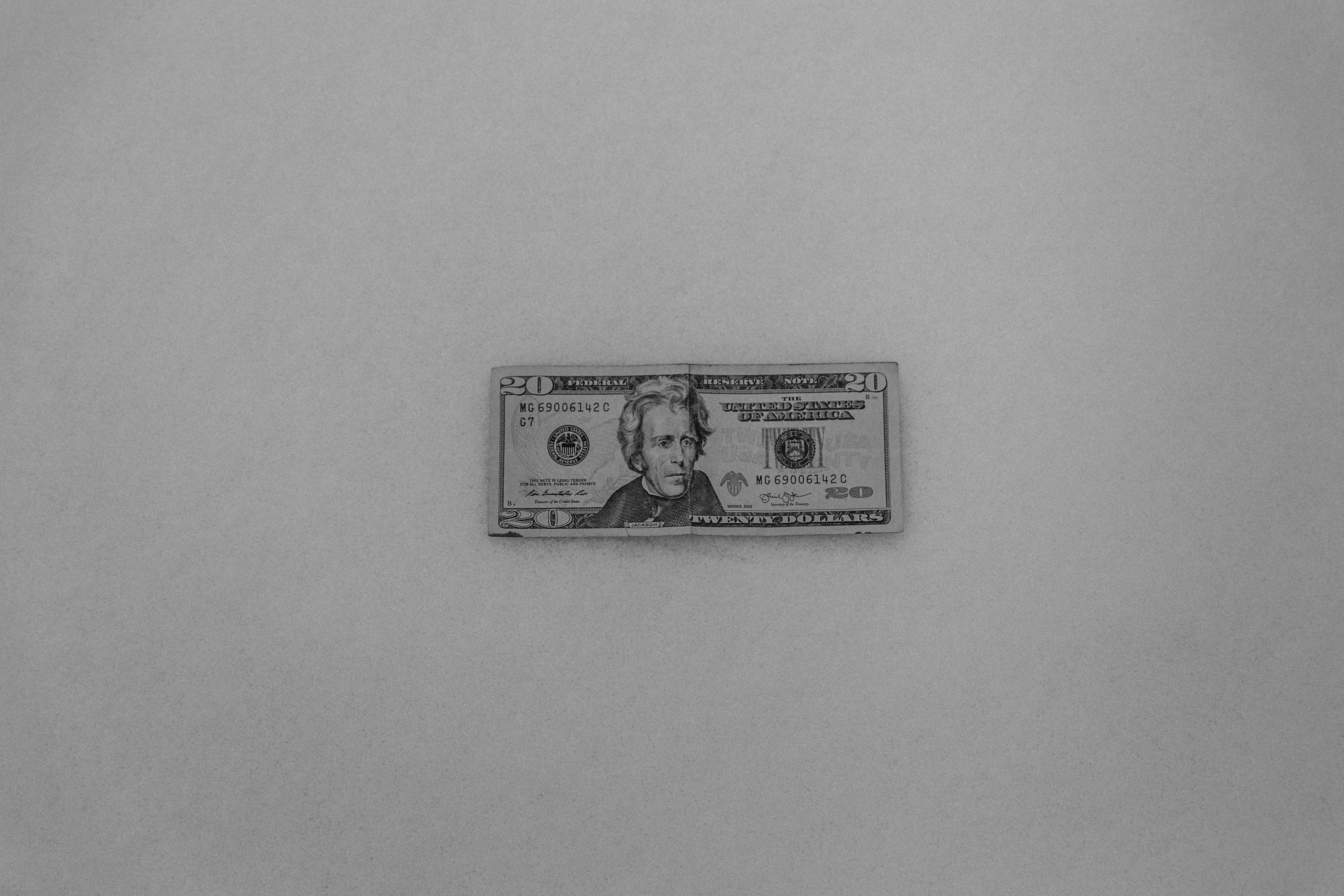 A set of modern house keys resting on a stack of dollar bills, illustrating increased equity for sellers.