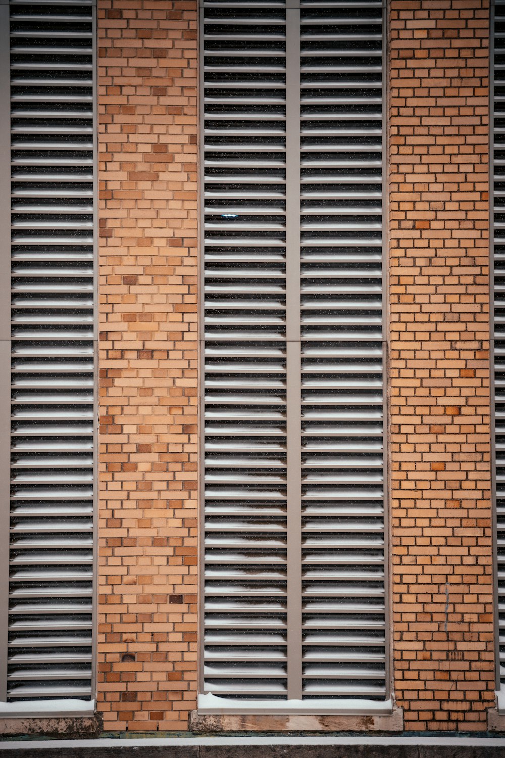 a person walking down a street past a brick building