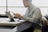 a man sitting in front of a laptop computer