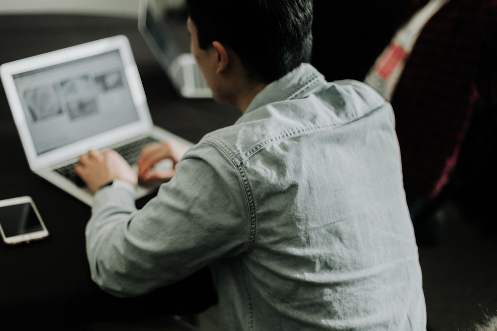 a man sitting in front of a laptop computer