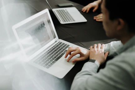 a man sitting in front of a laptop computer