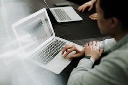a man sitting in front of a laptop computer