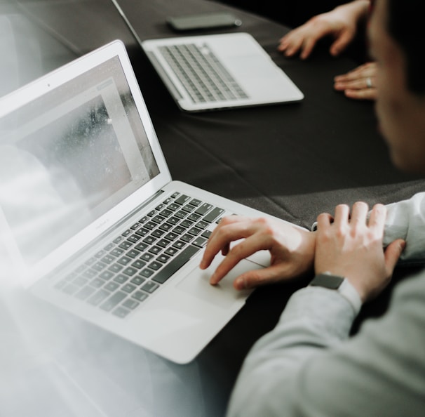 a man sitting in front of a laptop computer