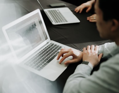 a man sitting in front of a laptop computer