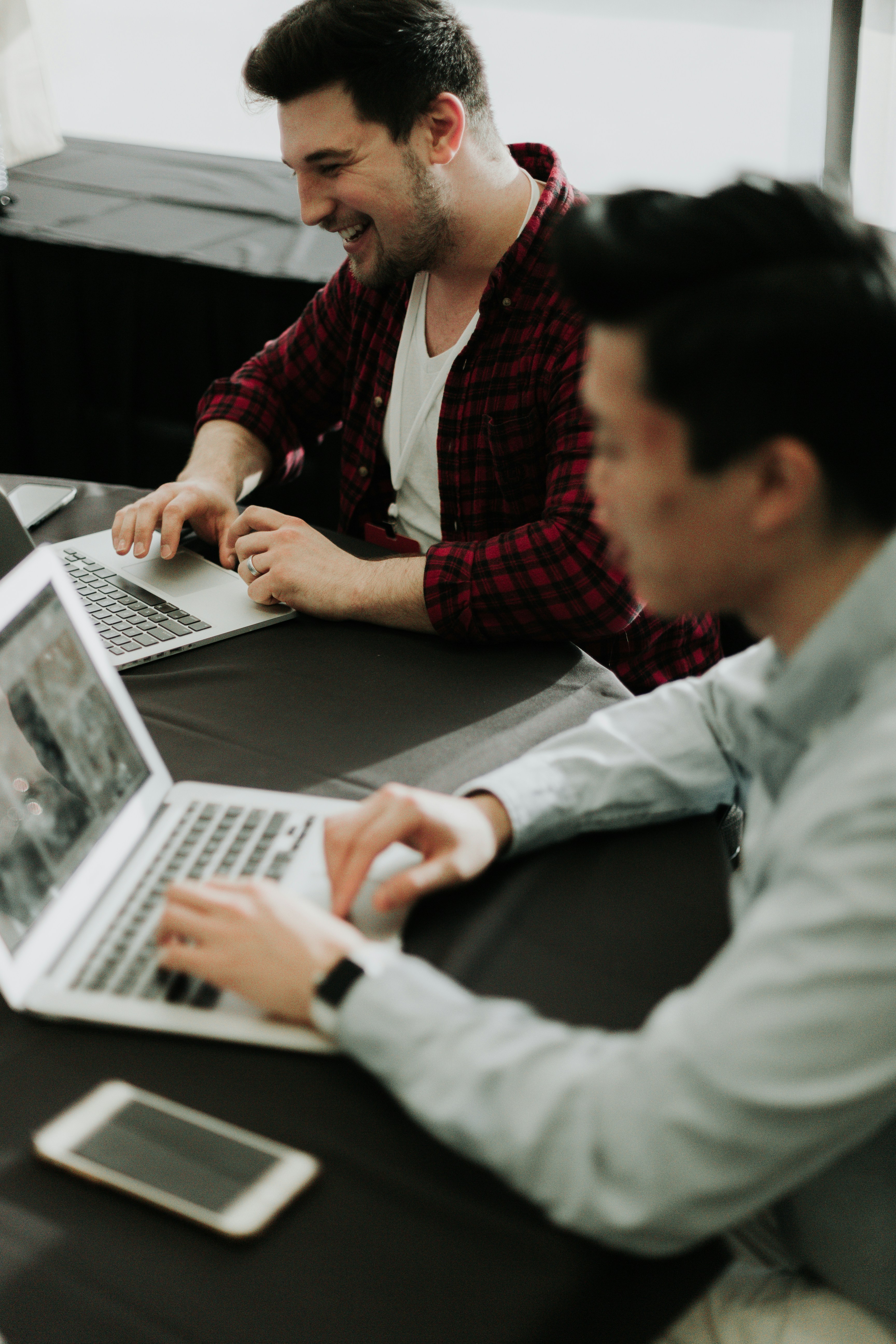2 individuals on their laptops