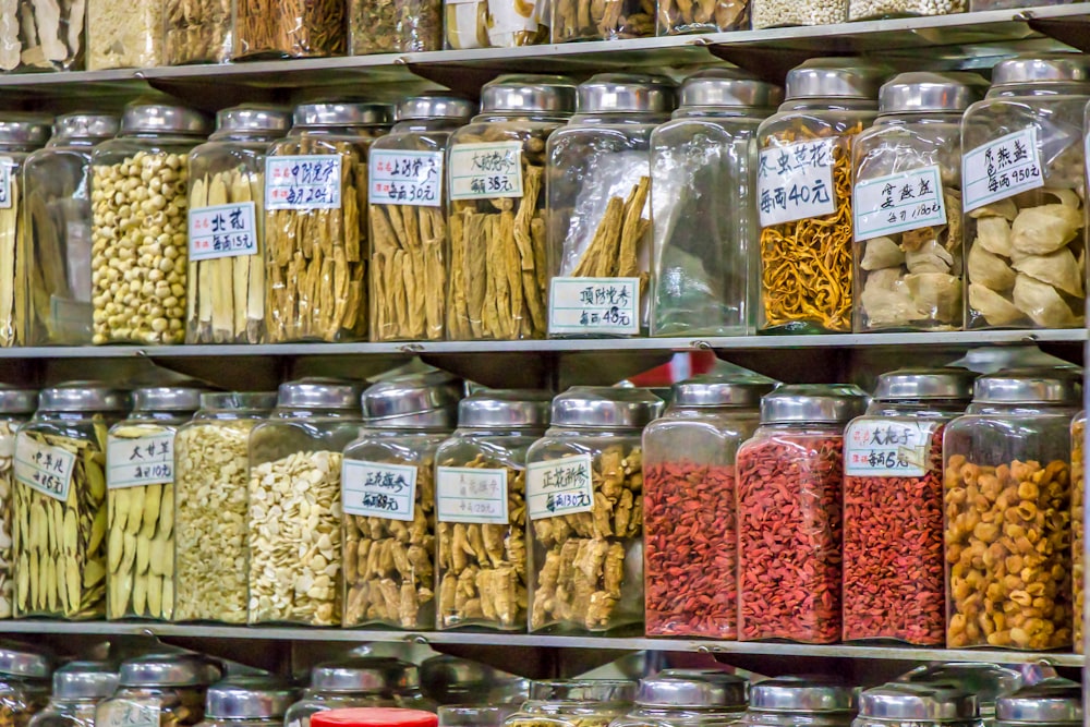 a variety of different kinds of food in glass jars