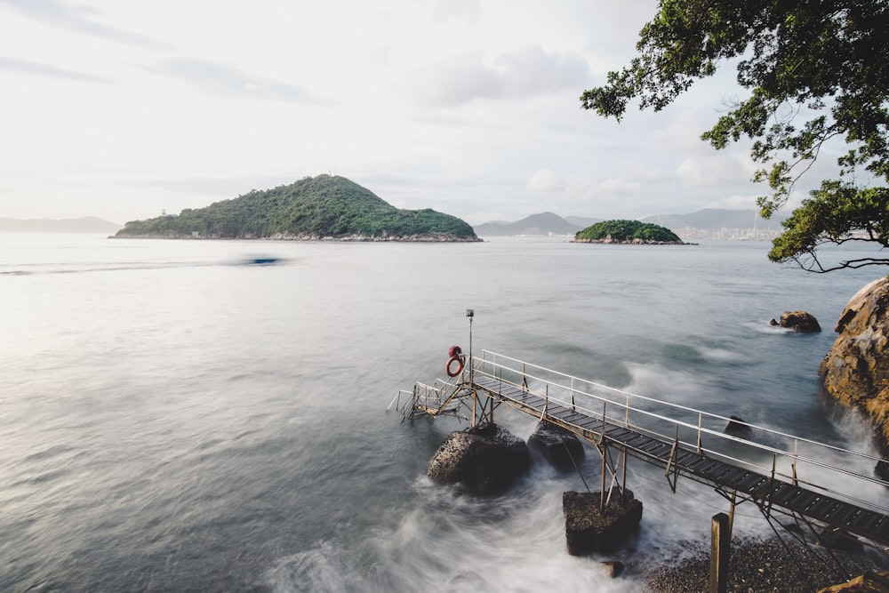 a person standing on a pier over a body of water