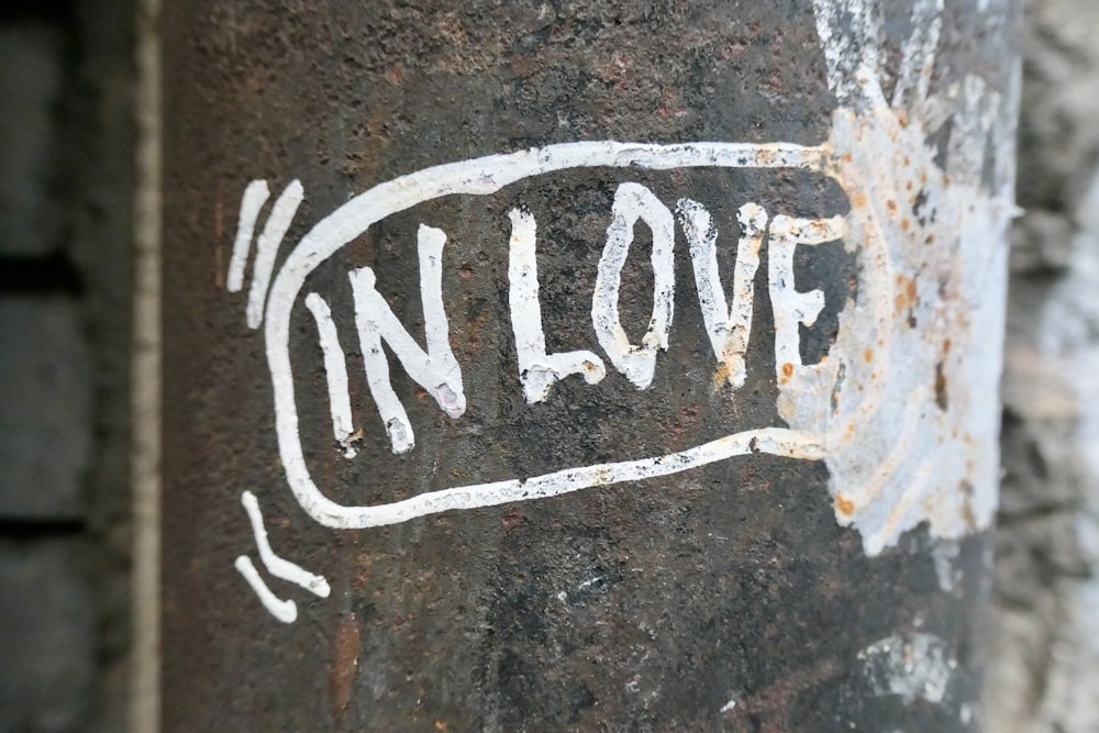 a sticker on a pole that says in love