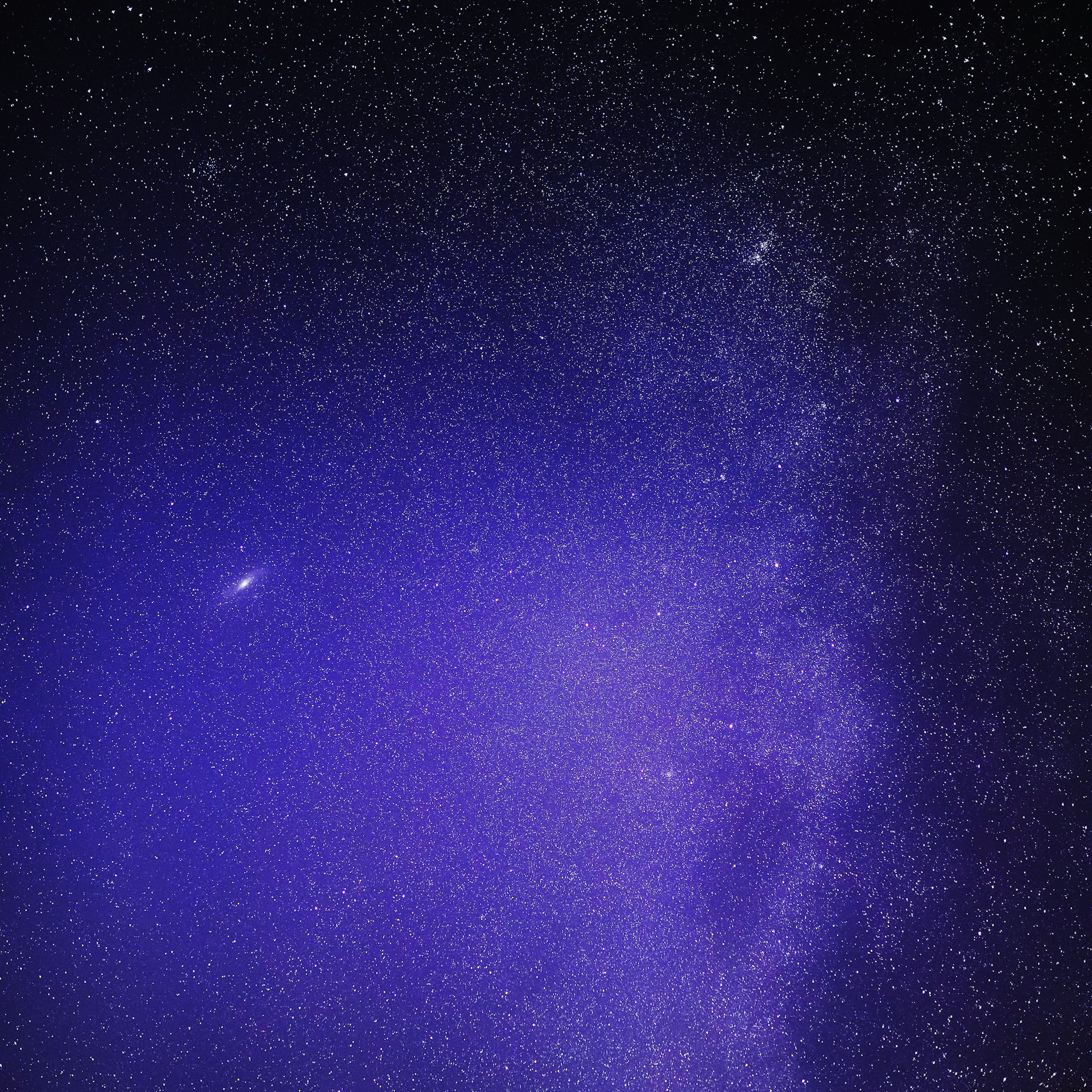 a night sky with stars and a bright purple light