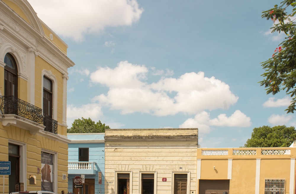 a row of buildings with cars parked in front of them