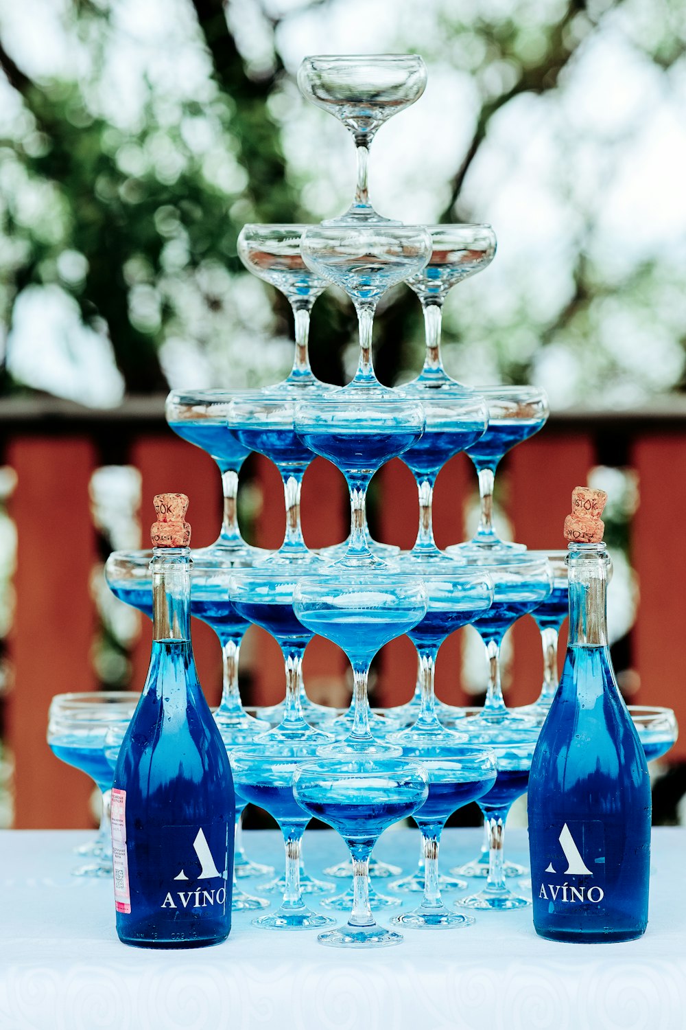 a stack of wine glasses sitting on top of a table