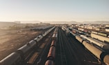 a train yard with many trains on the tracks