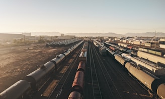 a train yard with many trains on the tracks