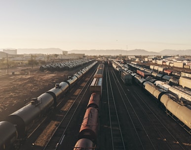 a train yard with many trains on the tracks