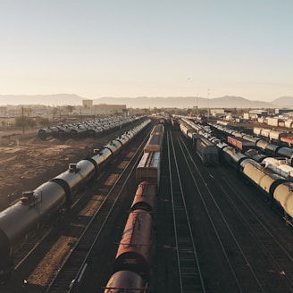 a train yard with many trains on the tracks