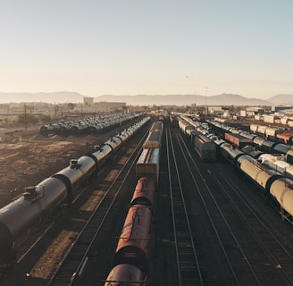 a train yard with many trains on the tracks
