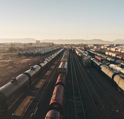 a train yard with many trains on the tracks