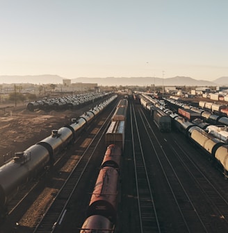 a train yard with many trains on the tracks