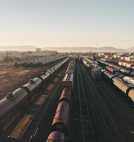 a train yard with many trains on the tracks