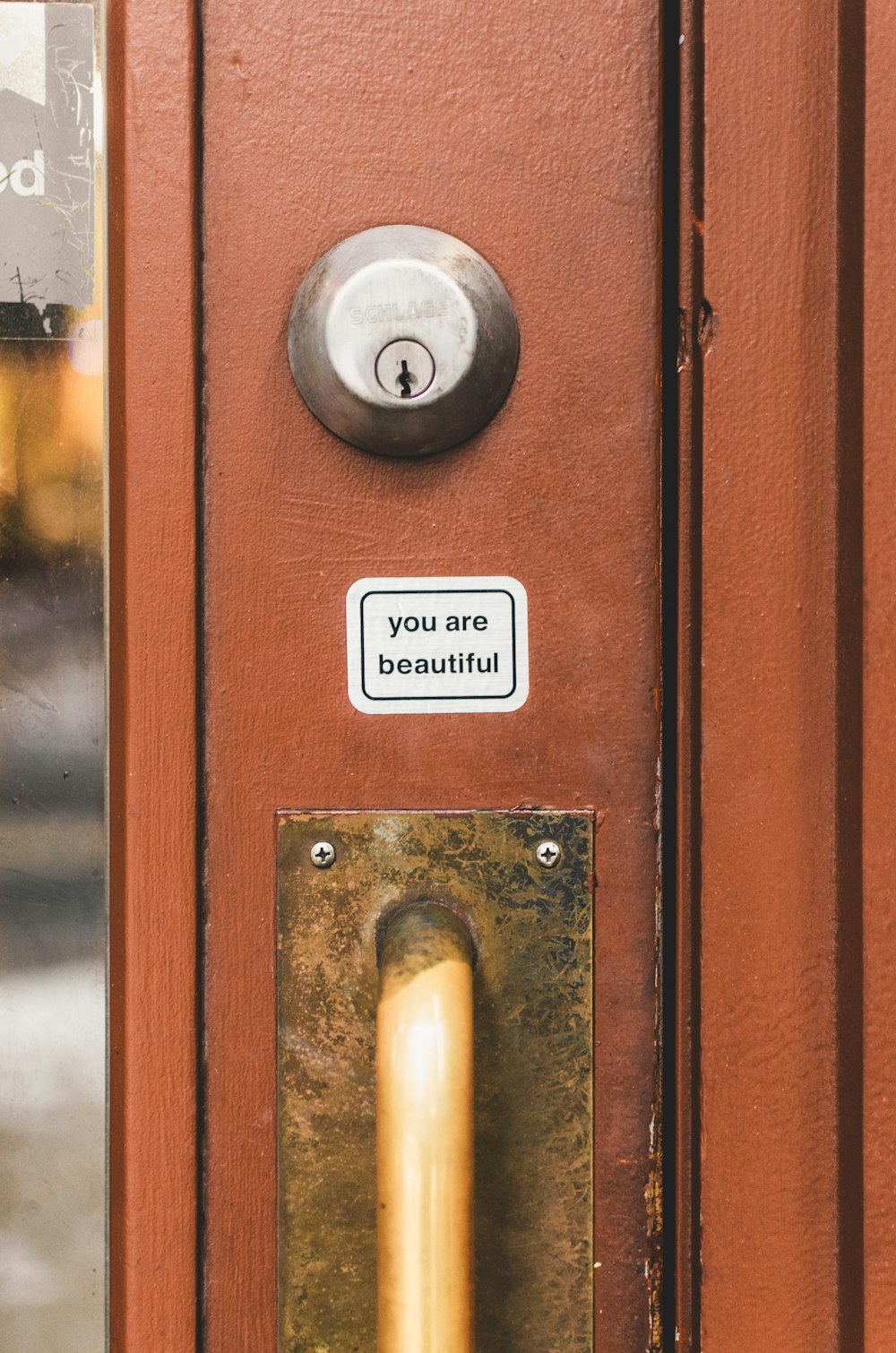 a close up of a door handle with a sign on it