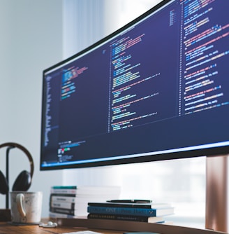 a computer monitor sitting on top of a wooden desk