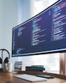 a computer monitor sitting on top of a wooden desk