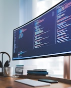 a computer monitor sitting on top of a wooden desk