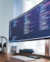 a computer monitor sitting on top of a wooden desk