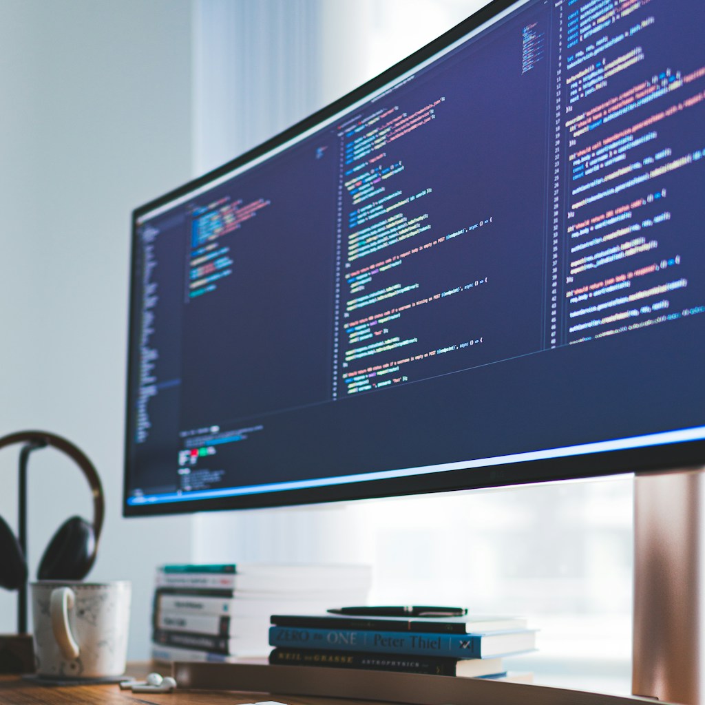 a computer monitor sitting on top of a wooden desk