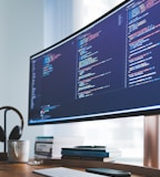 a computer monitor sitting on top of a wooden desk