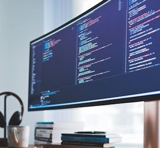 a computer monitor sitting on top of a wooden desk