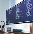 a computer monitor sitting on top of a wooden desk