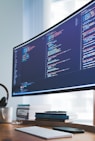 a computer monitor sitting on top of a wooden desk