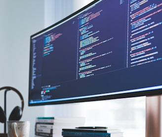 a computer monitor sitting on top of a wooden desk