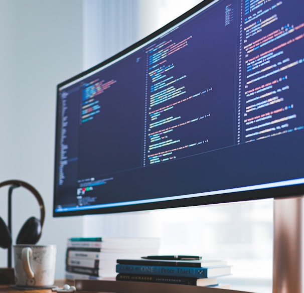 a computer monitor sitting on top of a wooden desk